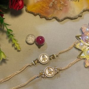 Ivory thread rakhi with a pearl cluster pendant