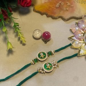 Sage green thread rakhi with a round kundan pendant and pearls